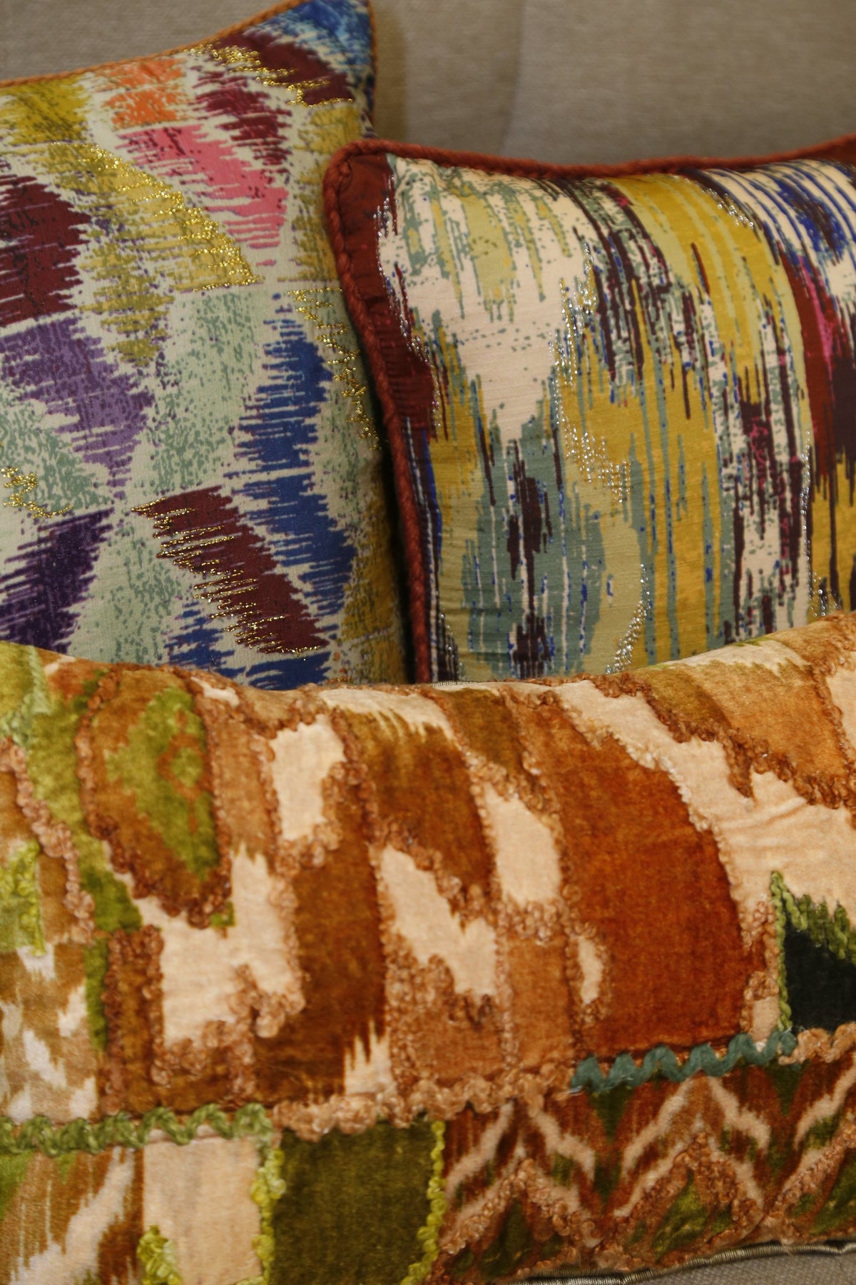 Forest green ikat velvet lumbar cushion styled with a multi ikat diamond cushion