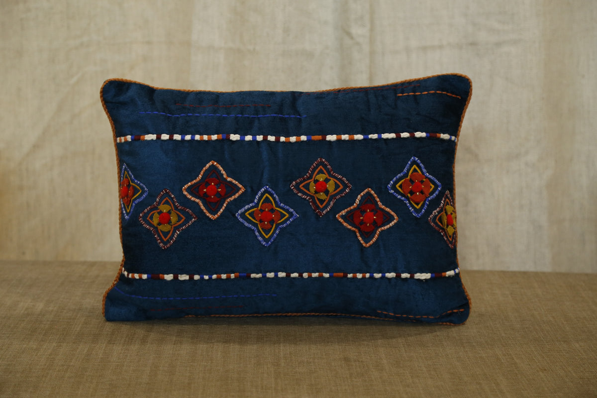 Blue hand-embroidered lumbar cushion cover, angled view showing decorative stitching