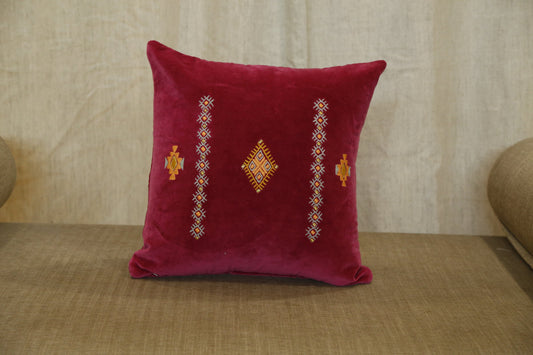 Ruby velvet cushion cover with vertical bands of traditional hand embroidery, front view
