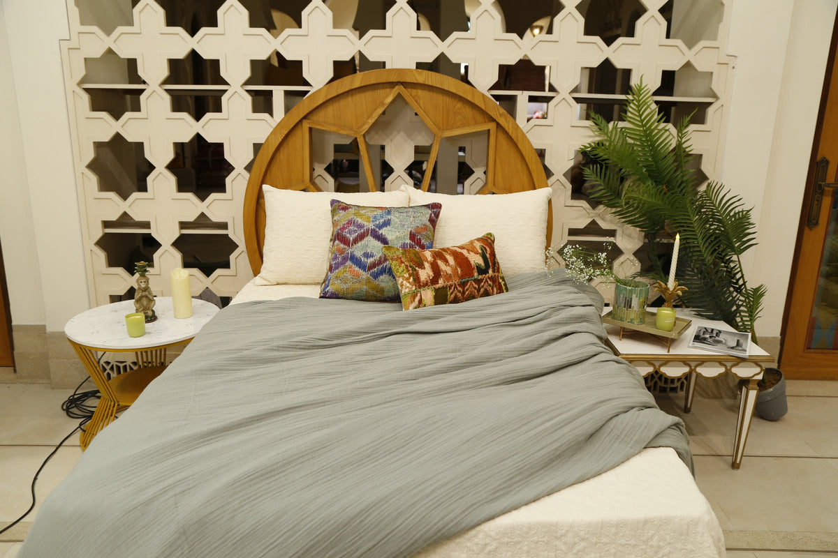 Grey slub bedcover set styled with the bird and vine and blue diamond cushion covers