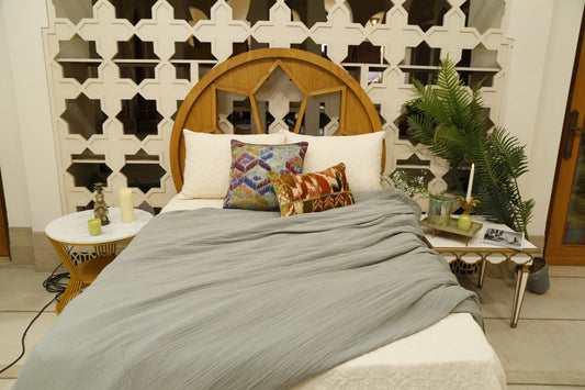 Grey slub bedcover set styled with the bird and vine and blue diamond cushion covers