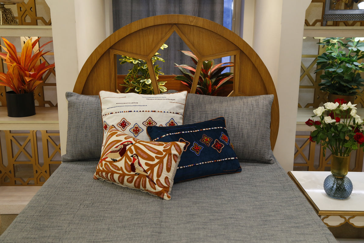 Grey slub bedcover set, wider room view with the styled cushion arrangement