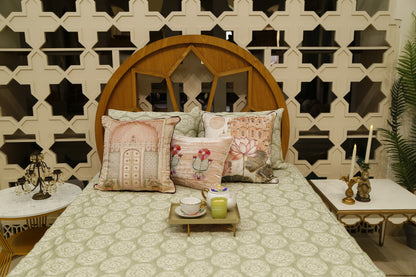 Sage green block printed bedcover set with blush jharokha and lotus cushion covers