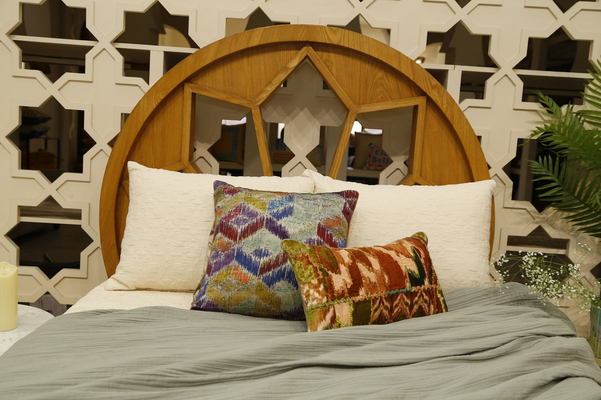 Sage crinkle bedding set shown full length with the ikat cushion arrangement