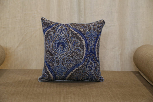 Silver blue paisley printed silk cushion cover styled on a bench, front view, 18x18 inches
