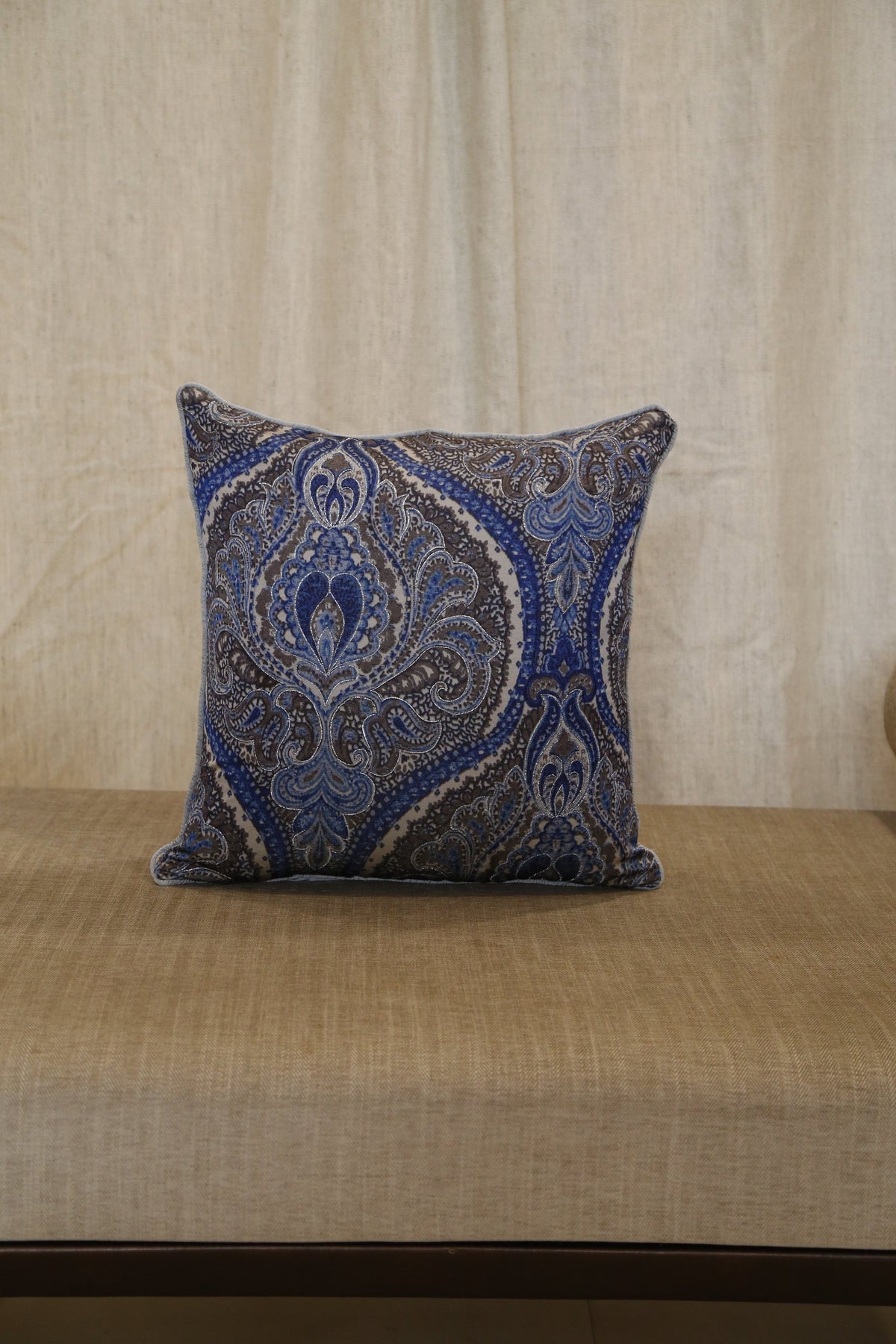 Silver blue paisley silk cushion cover, angled view showing hand embroidery detail
