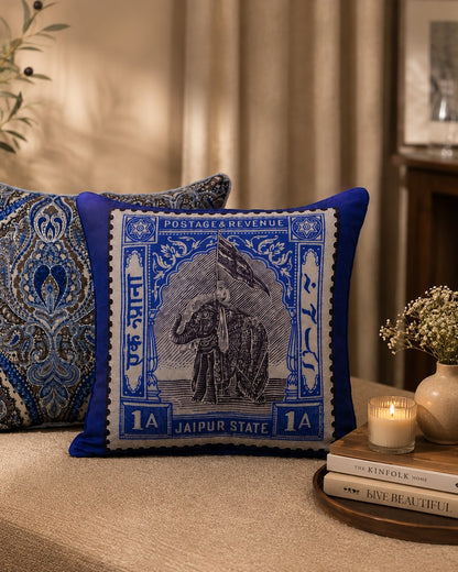 Jaipur elephant stamp cushion styled with a paisley cushion beside a candle