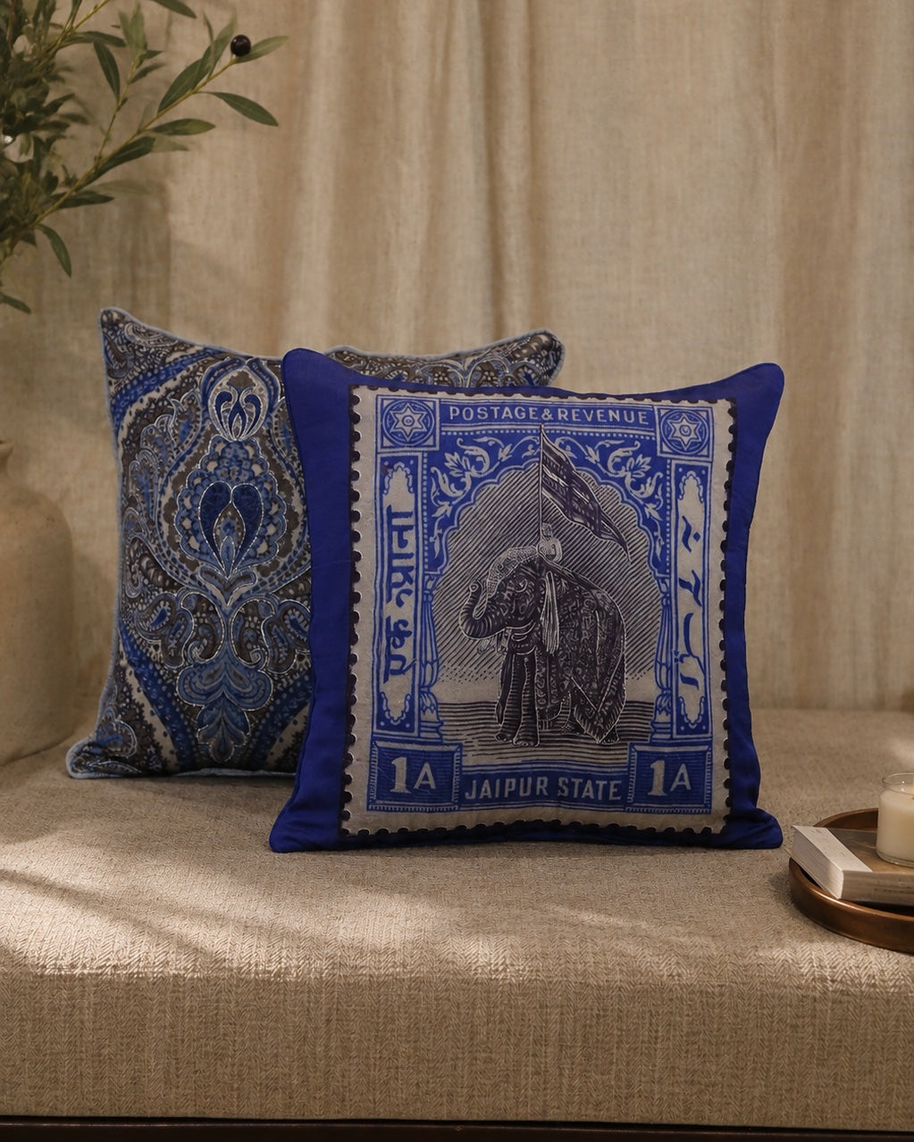 Jaipur elephant stamp cushion styled on a jute rug with brass and lotus accents