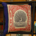 Silk cushion cover printed with a Jaipur State peacock postage stamp in blush pink on royal blue, 18x18 inches