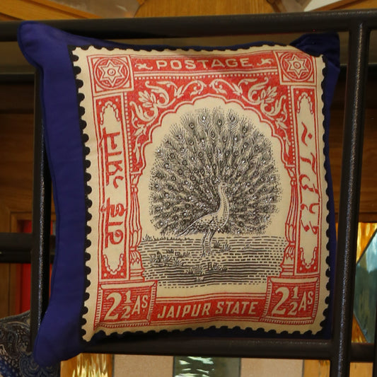 Silk cushion cover printed with a Jaipur State peacock postage stamp in blush pink on royal blue, 18x18 inches