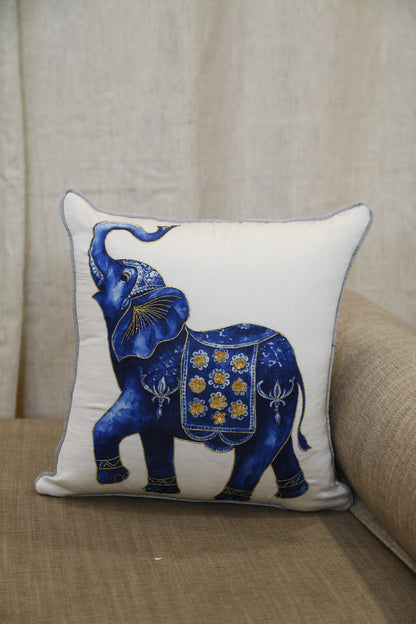 Into the Blue elephant cushion cover, angled view against a linen bolster