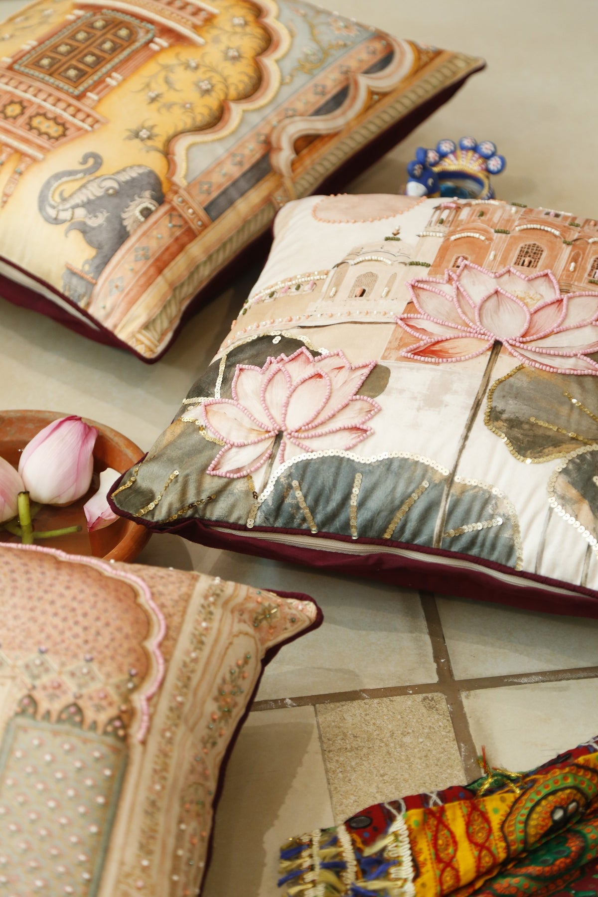 Lotus Palace beaded velvet cushion cover styled with brass and fresh lotus
