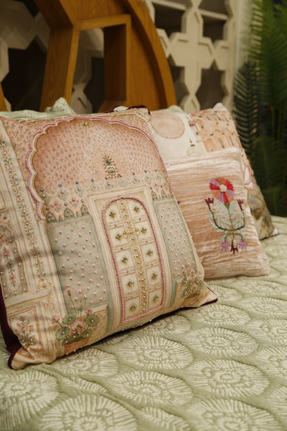 Blush pink jharokha cushion cover with lotus cushion, styled on a sage bedcover