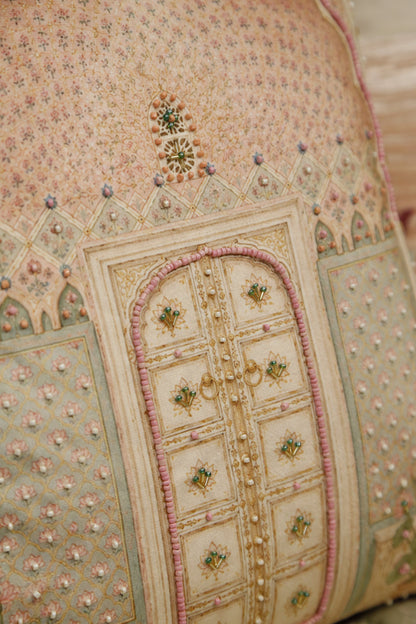 Close detail of the jharokha window motif and bead embroidery on blush pink velvet