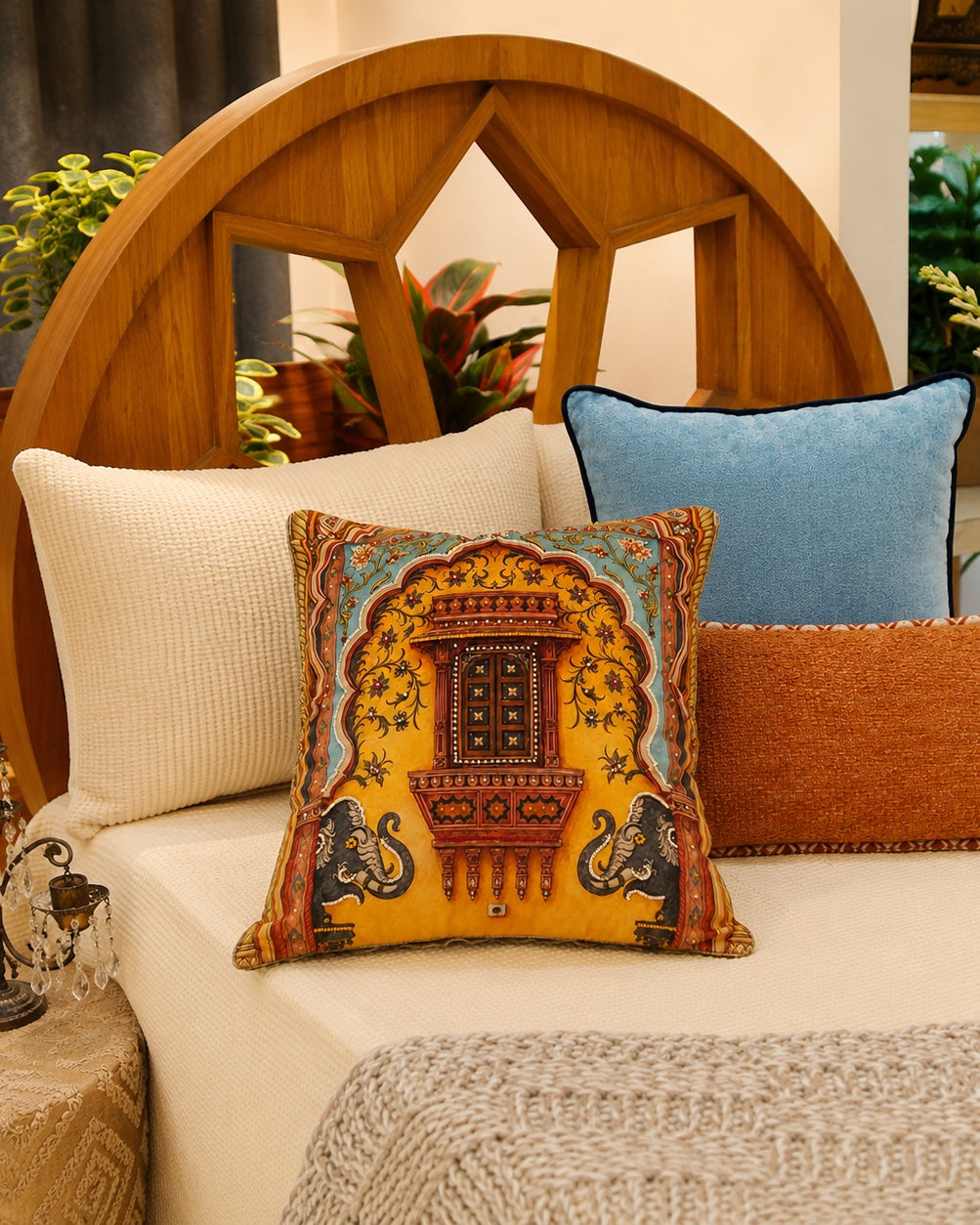 Royal Jharokha cushion on a bed against a carved teak headboard