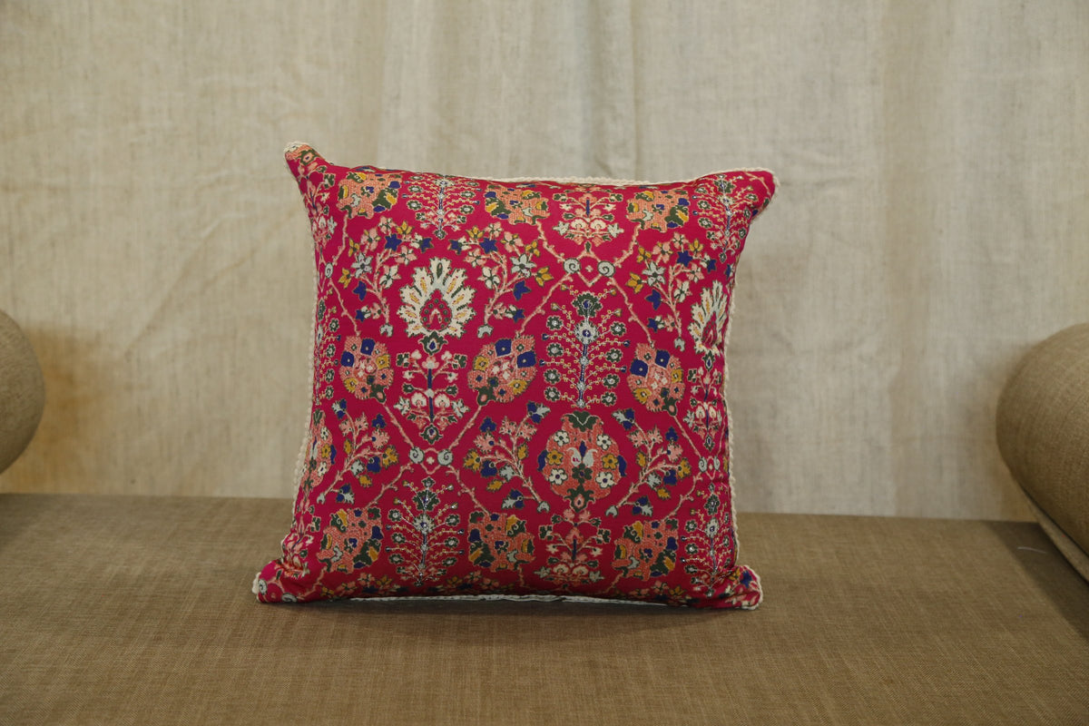 Close detail of the hand embroidery on the ruby red floral silk cushion cover