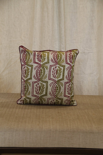 Olive green trellis silk cushion cover styled on a linen bench