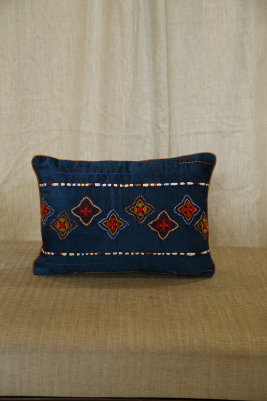 Indigo blue lumbar cushion cover with traditional diamond embroidery, front view