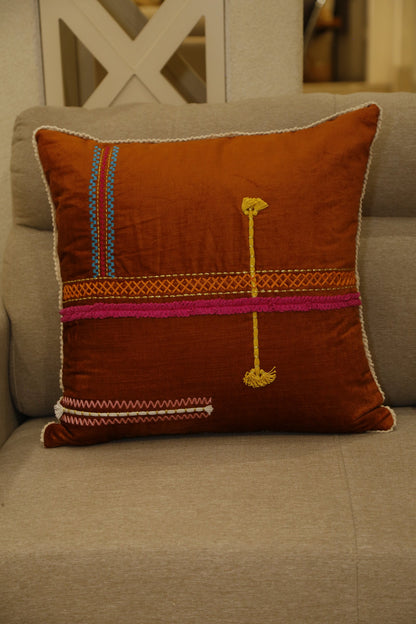 Rust cushion cover with magenta band and traditional hand embroidery, front view