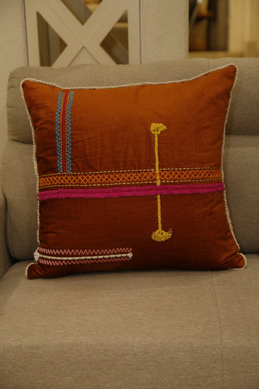 Rust cushion cover with magenta band and traditional hand embroidery, front view
