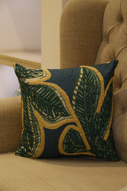 Forest green cotton slub cushion cover with oversized gold-outlined leaf embroidery, front view