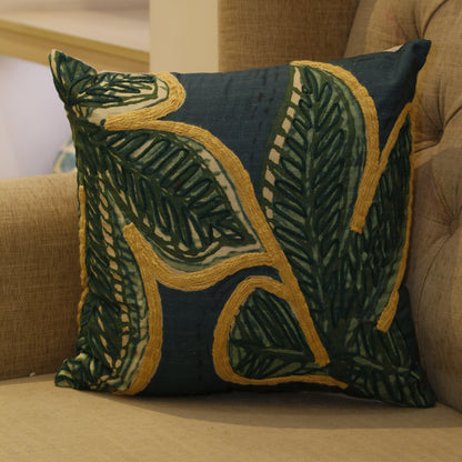 Forest green cotton slub cushion cover with oversized gold-outlined leaf embroidery, 18x18 inches